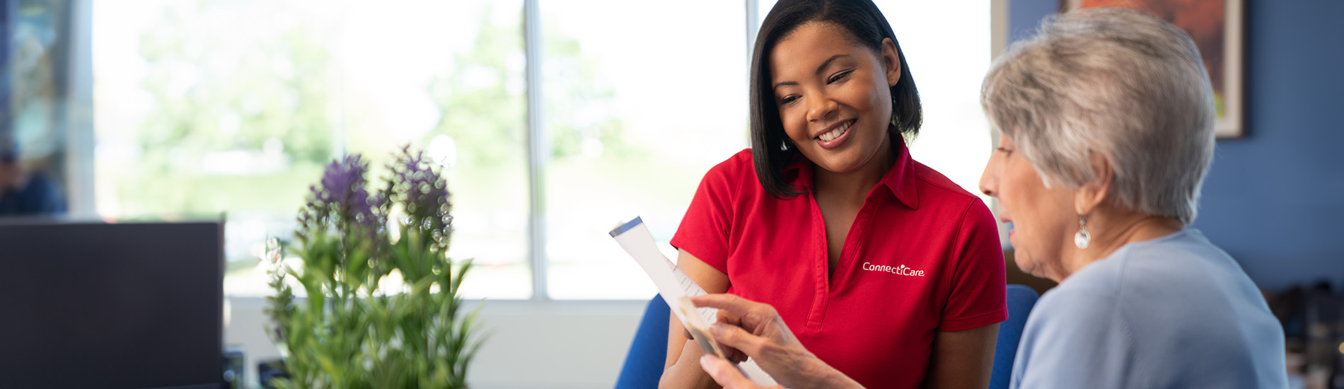 sales rep with customer reviewing document and smiling