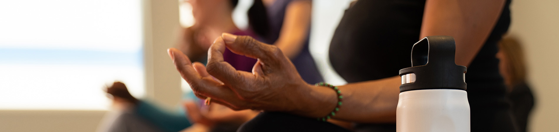 women practicing meditation in a group setting